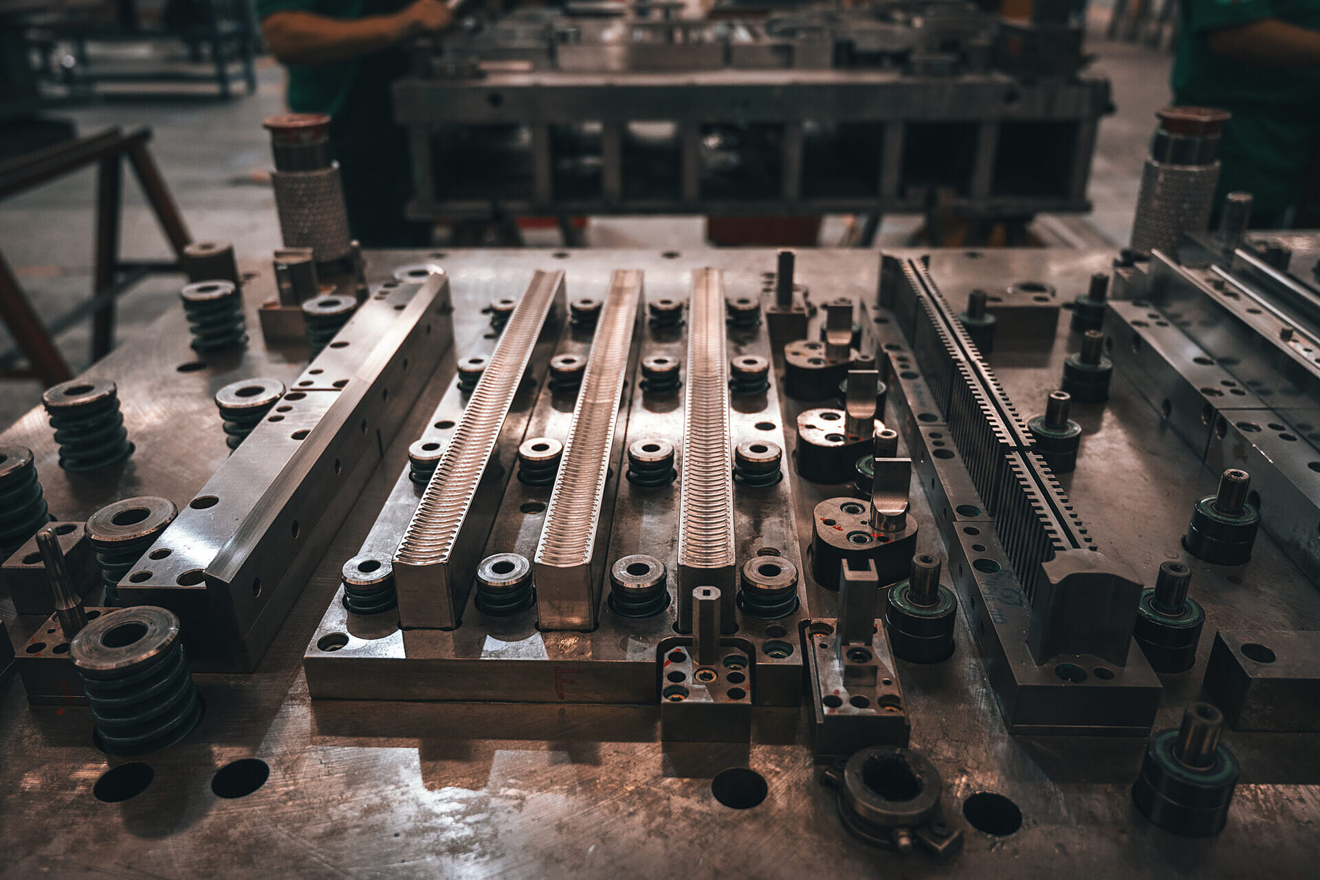 Precision die (troquel) components on the toolroom bench at TONALI