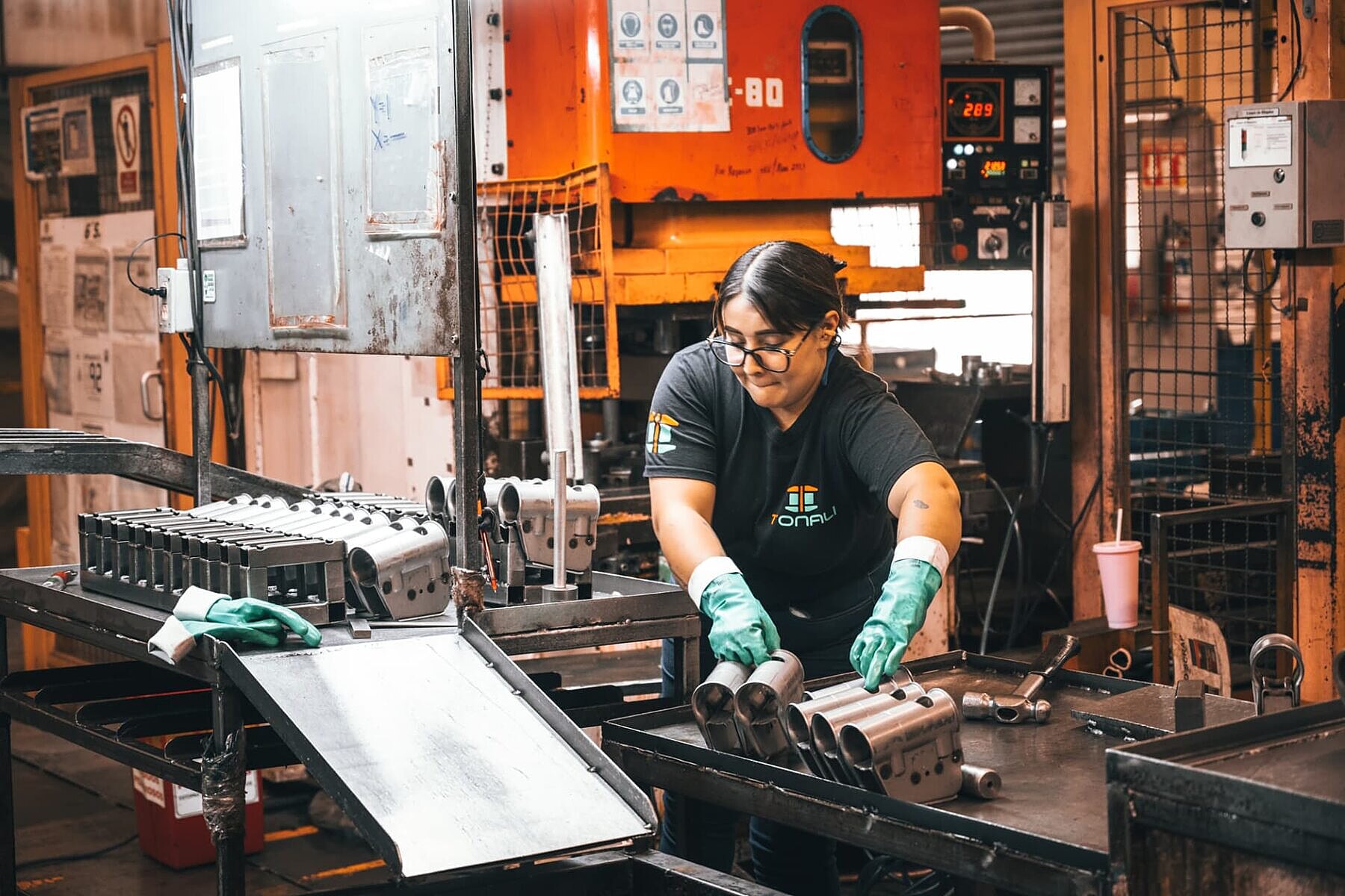 TONALI operator running a stamping cell on the plant floor